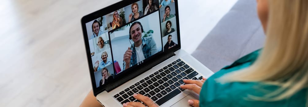 Businesswoman making video call to business partner using laptop. Close-up rear view of young woman having discussion with corporate client. Remote job interview, consultation, human resources concept.