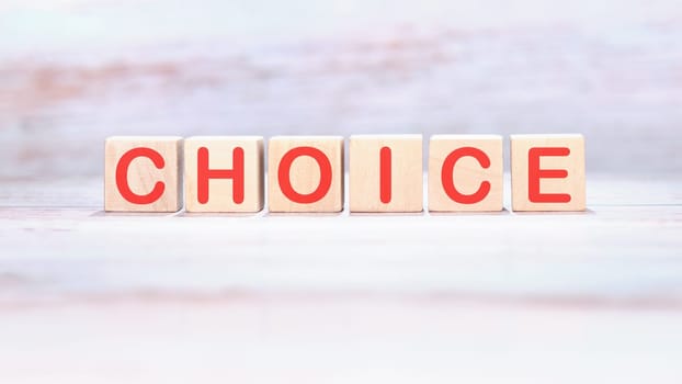 CHOICE word made of wooden cubes on a light background