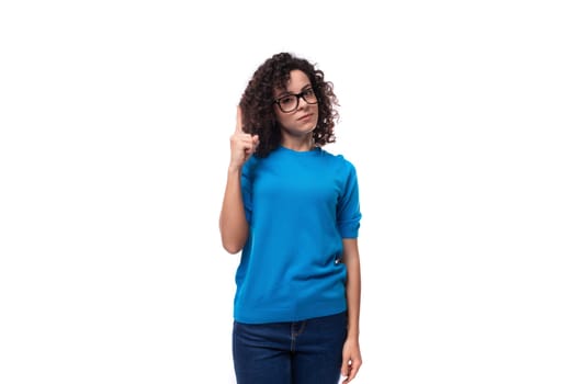 confident successful young caucasian woman with curls dressed in a blue t-shirt.