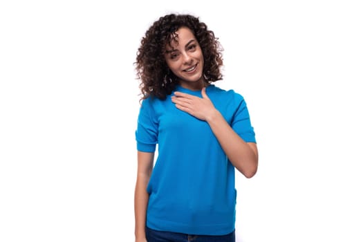 young happy woman dressed in a blue t-shirt made curly hair styling.