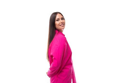 stylish caucasian woman with black straight hair is dressed in a crimson shirt on a white background.