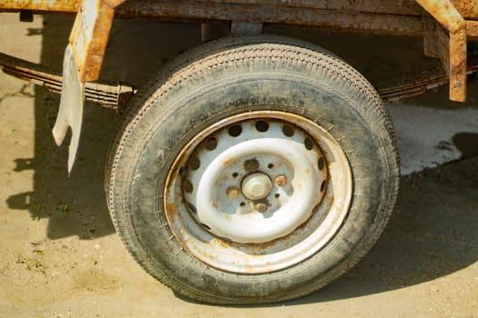 Wheel of car. Transport details. Old wheel on car. Rusty cart.