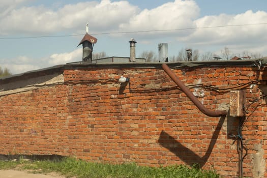 Old building in city. Industrial area. Details of industrial-looking architecture. Worn-out house.