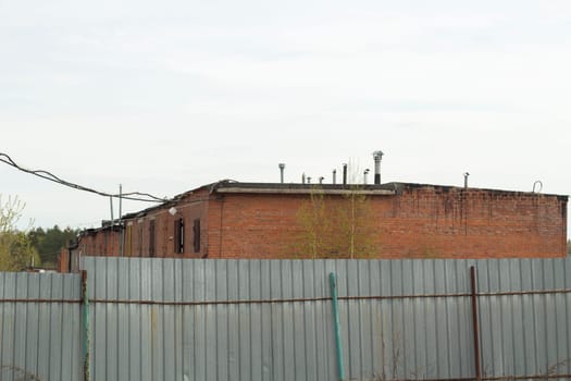 Old building in city. Industrial area. Details of industrial-looking architecture. Worn-out house.