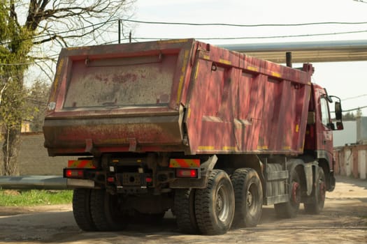 Truck with body enters industrial area. Transportation of building materials. Garbage collection.