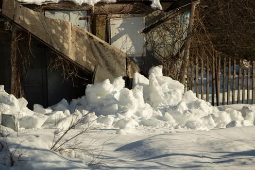 I'm on old barn. Snow fell from cabin. Snowy winter in Russia. Old building.