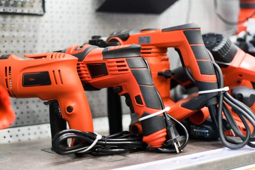 Power tools, drills and hammers of various manufacturers are sold in hardware store.