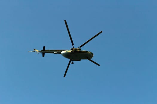 Helicopter in sky. Air transport flies across sky. Flight details. Propeller blades.