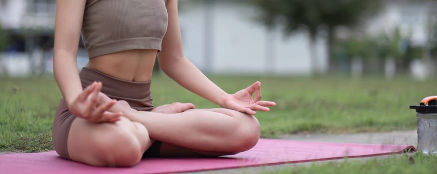 Young Asian woman exercise Do yoga in the park to improve your health..