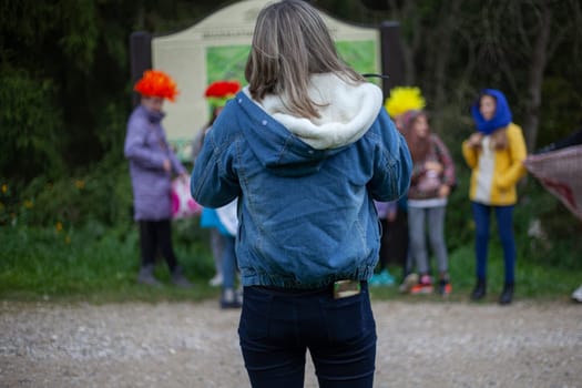 Student in blue jeans and black jeans. Woman on excursion in manor.