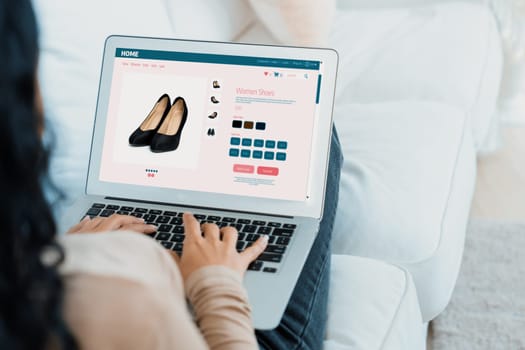 Woman shopping online on internet marketplace browsing for sale items for modern lifestyle and use credit card for online payment from wallet protected by crucial cyber security software