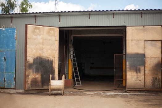 Garage door. Entrance to warehouse. Large gate to building. Industrial zone. Entrance for large vehicles.