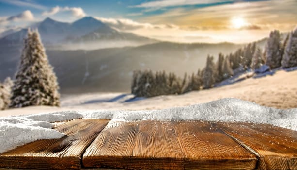 Wooden desk cover of snow and frost with christmas tree branch decoration.