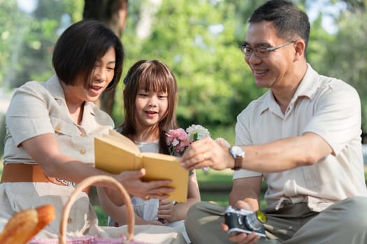 family picnic with child and grandparents for healthy growth development, outdoor wellness lifestyle.