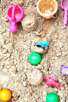 Children's sandbox with various toys for the game in summer day
