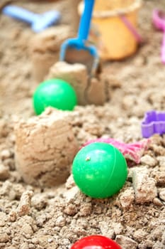 Children's sandbox with various toys for the game in summer day