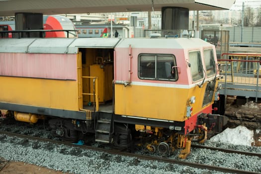 Construction train. Repair of railway. Yellow train for laying railway tracks.