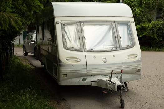 Caravan in parking lot. Trailer for car. Car for travel. Trailer with sleeping place.