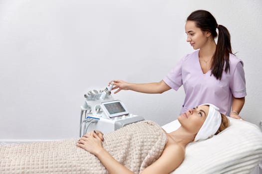 beautiful woman lying on bed during skincare procedure in beauty clinic.