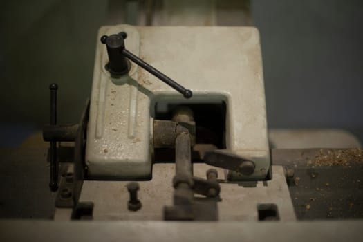 Iron lever mechanism. Old thing in garage. Steel block with lever. Detail of engine mechanism.