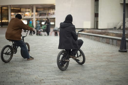 Guys on bikes. BMX bike. Extreme sports in city. Teenagers ride.