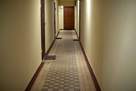 Corridor in house. Tiles in house. Doors in hallway. Entrances were flown. Interior of residential building.