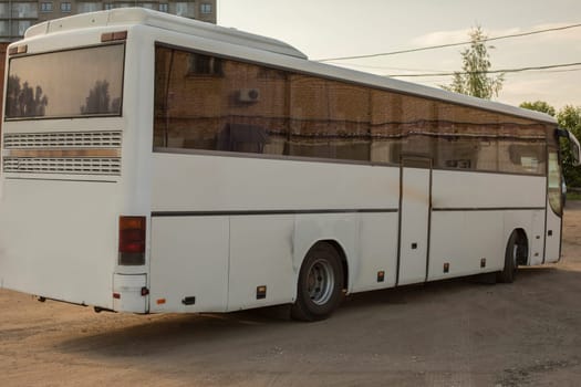 White bus. Bus at bus stop. Public transport. Trip between cities.