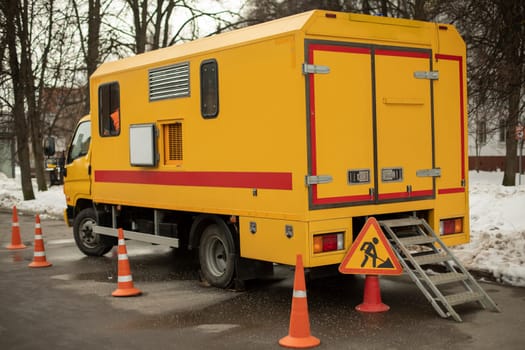 Emergency service on street. Car for repair. Yellow transport. Special equipment in city.