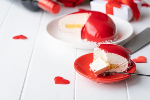 Valentines day. heart shaped glazed valentine cake and flowers on wooden table