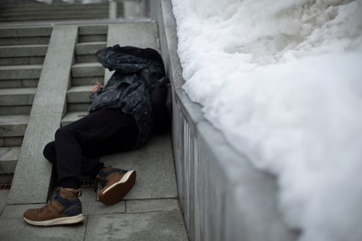 Man fell. Guy is lying on pavement. Falling on stairs. Man stumbled. Loss of balance.