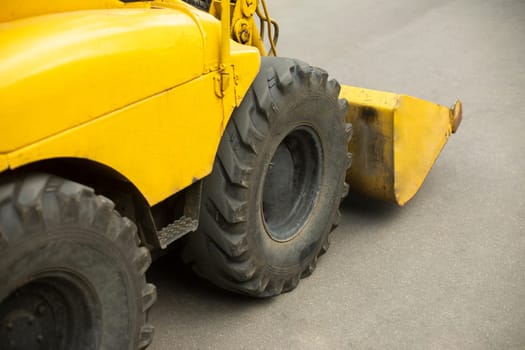 Yellow mini bulldozer. Small construction equipment. Diesel transport. Yellow conveyor.