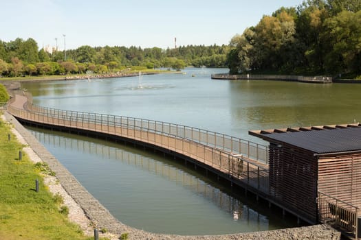 Embankment on lake. View of park. City Pond. Details of design of embankment.