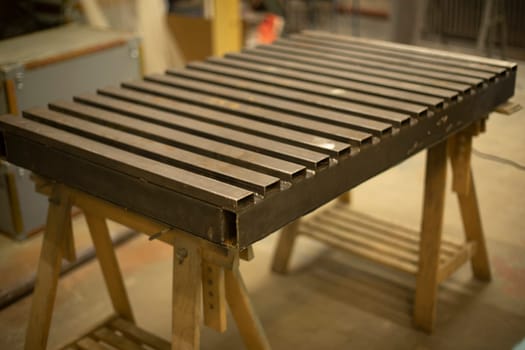 Steel table. Industrial processing. Details of work with structure. Part processing. Steel cover.