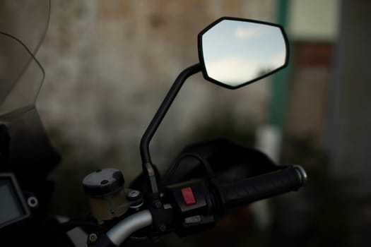 Rear-view mirror on motorcycle. Mirror on bike. Overview view.