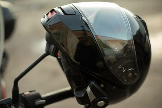 Motorcyclist helmet. Black helmet on motorcycle. Security tool. Head protection.