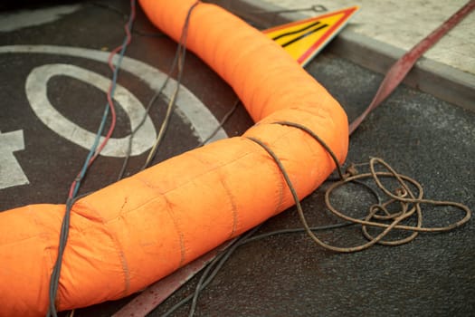 Sewer repair. Orange pipe. Details of works in city. Repair of infrastructure.