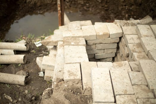 Unsuccessful construction. Stone blocks lie crookedly. Details of construction of sewerage.