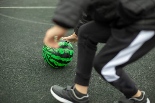 Relay for children. Sports game. Children roll meat around playground. Fun in summer. Competition for agility.