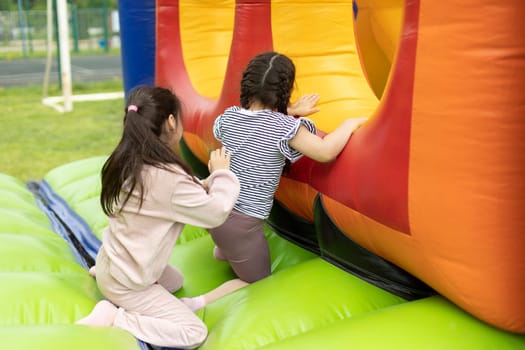 Child on obstacle course. Children's entertainment area. Inflatable design for children.