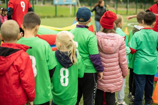 Children at sports competition. Kids on obstacle course. Queue of children. Amusement park.