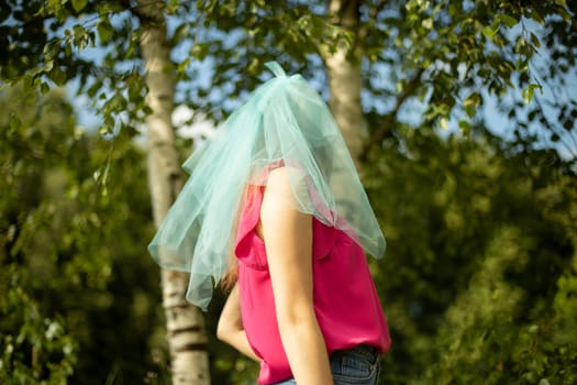 Girl in blue cape on her head. Transparent fabric at bridesmaid's. Blue veil on girl. Decoration Details.