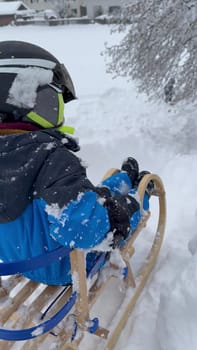 Child on Wooden Sled Enjoying Snowy Day.