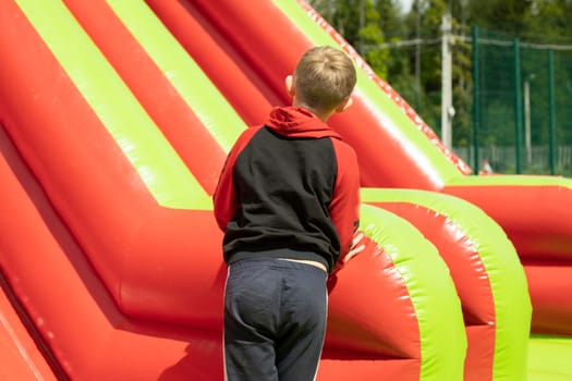 Child on obstacle course. Child in amusement park. Rest in summer. Active lifestyle.