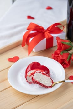 Valentines day. heart shaped glazed valentine cake and flowers in wooden tray