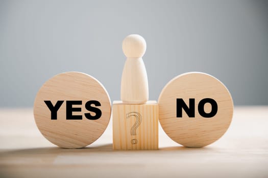 Wooden block choice showcases people's conflict between right and wrong contemplating yes or no decisions. True and false symbols on wood illustrate business dilemmas. Think With Yes Or No Choice.