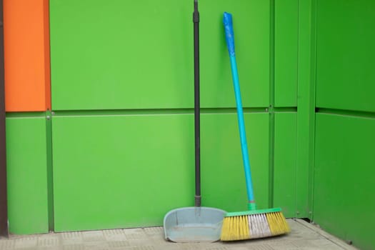 Broom and garbage can. Cleaning products. Broom with long handle.