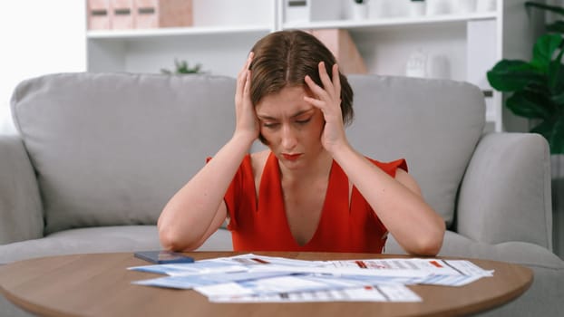 Stressed young woman has financial problems with credit card debt to pay prim from bad personal money and mortgage pay management crisis. Woman worry about financial bankruptcy risk from over spending