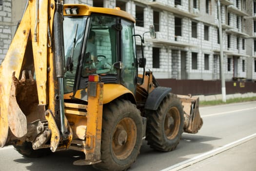 Yellow tractor, Construction machinery in city. Heavy vehicles with big wheels. Construction details .