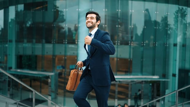 Successful business man celebrate for getting promotion while walking to office. Caucasian receive good news about sales increase or successful project. Manager feel overjoy and happy. Exultant.