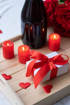 Valentines day. valentine gift box and candles in wooden tray